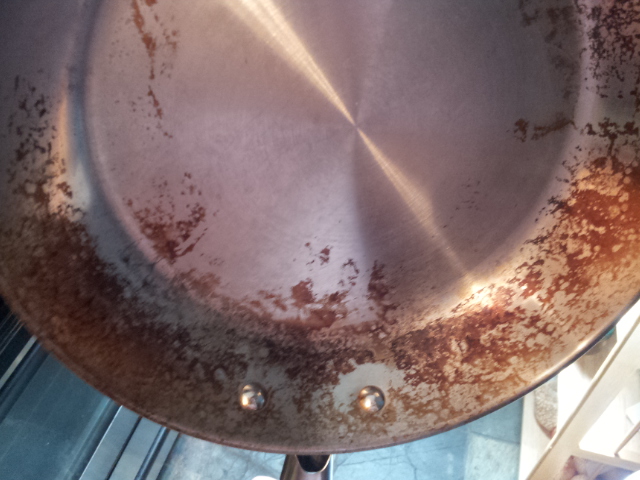 How do I clean really baked on grease off my steel cookware?